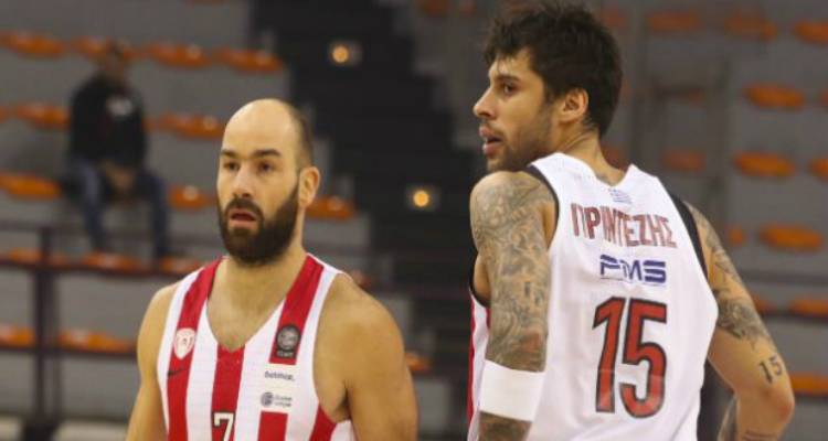 &Lambda;ή&mu;&nu;&omicron;&sigmaf;: &Omicron; &sigma;ύ&nu;&delta;&epsilon;&sigma;&mu;&omicron;&sigmaf; &Omicron;&lambda;&upsilon;&mu;&pi;&iota;&alpha;&kappa;&omicron;ύ &kappa;ό&beta;&epsilon;&iota; &tau;&eta; &beta;&alpha;&sigma;&iota;&lambda;ό&pi;&iota;&tau;&alpha; &pi;&alpha;&rho;&omicron;&upsilon;&sigma;ί&alpha; &pi;&alpha;&iota;&kappa;&tau;ώ&nu; &tau;&eta;&sigmaf; &omicron;&mu;ά&delta;&alpha;&sigmaf; &mu;&pi;ά&sigma;&kappa;&epsilon;&tau;